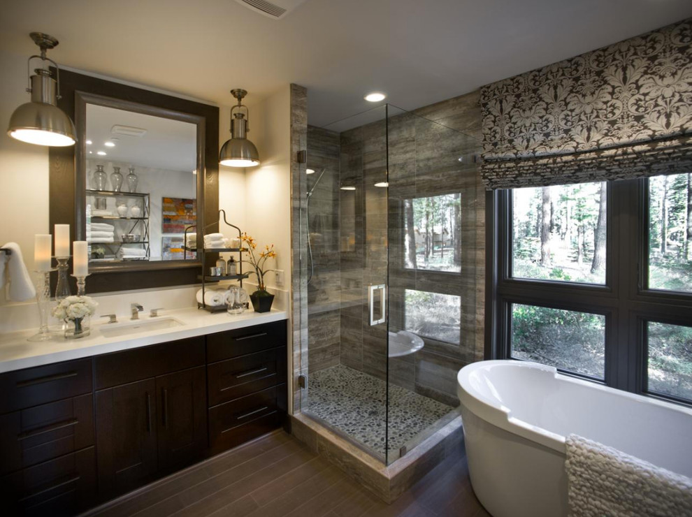 Example of a mid-sized transitional master freestanding bathtub design in Orange County with flat-panel cabinets, dark wood cabinets, a one-piece toilet, white walls, an undermount sink and solid surface countertops