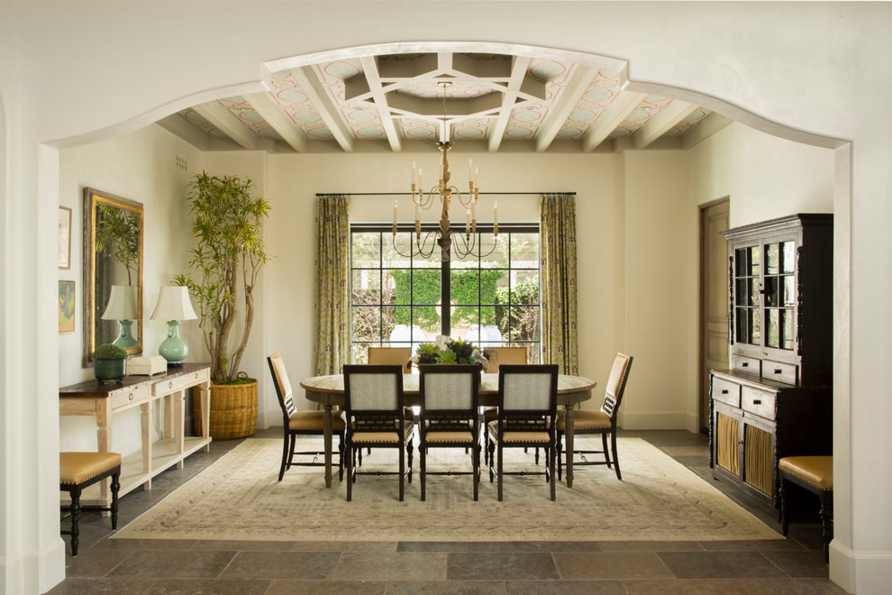 This is an example of a mediterranean dining room in Seattle with white walls and grey floor.