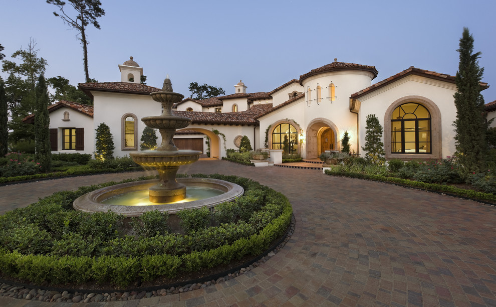 Inspiration for a large mediterranean exterior in Austin with a tile roof.