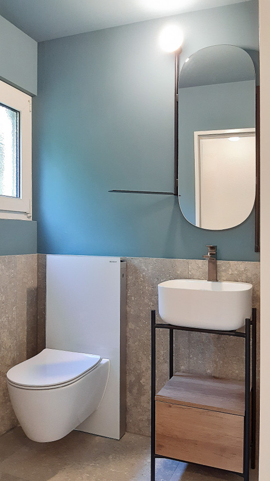 Photo of a small contemporary cloakroom in Milan with light wood cabinets, grey tiles, stone slabs, blue walls, limestone flooring, a vessel sink, grey floors and a freestanding vanity unit.