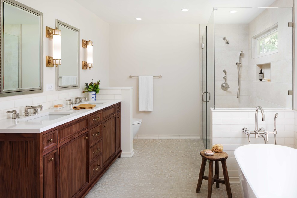 Mid-sized traditional master bathroom in Portland with white tile, ceramic tile, beige walls, mosaic tile floors, an undermount sink, engineered quartz benchtops, a hinged shower door, white benchtops, recessed-panel cabinets, dark wood cabinets, a freestanding tub, a corner shower and beige floor.