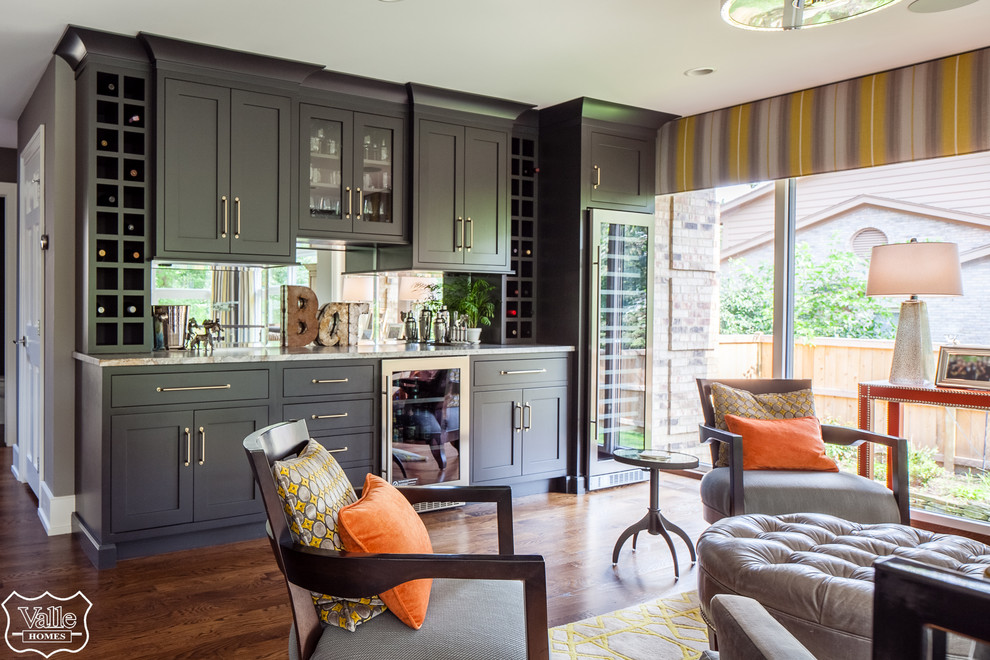 Large transitional single-wall medium tone wood floor and brown floor eat-in kitchen photo with an undermount sink, shaker cabinets, black cabinets, marble countertops, mirror backsplash, stainless steel appliances and gray countertops