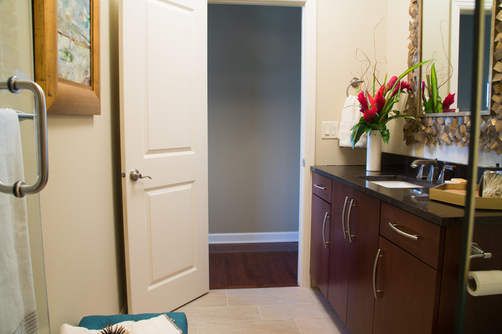 Mid-sized transitional 3/4 beige tile and ceramic tile ceramic tile alcove shower photo with flat-panel cabinets, dark wood cabinets, a two-piece toilet, beige walls, an undermount sink and granite countertops
