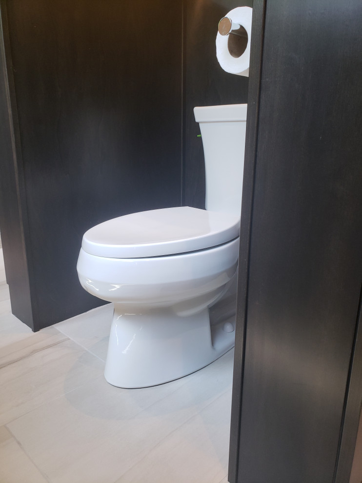 Large modern cloakroom in Other with shaker cabinets, dark wood cabinets, a one-piece toilet, porcelain flooring, an integrated sink, engineered stone worktops, beige floors, black worktops, a built in vanity unit and a vaulted ceiling.