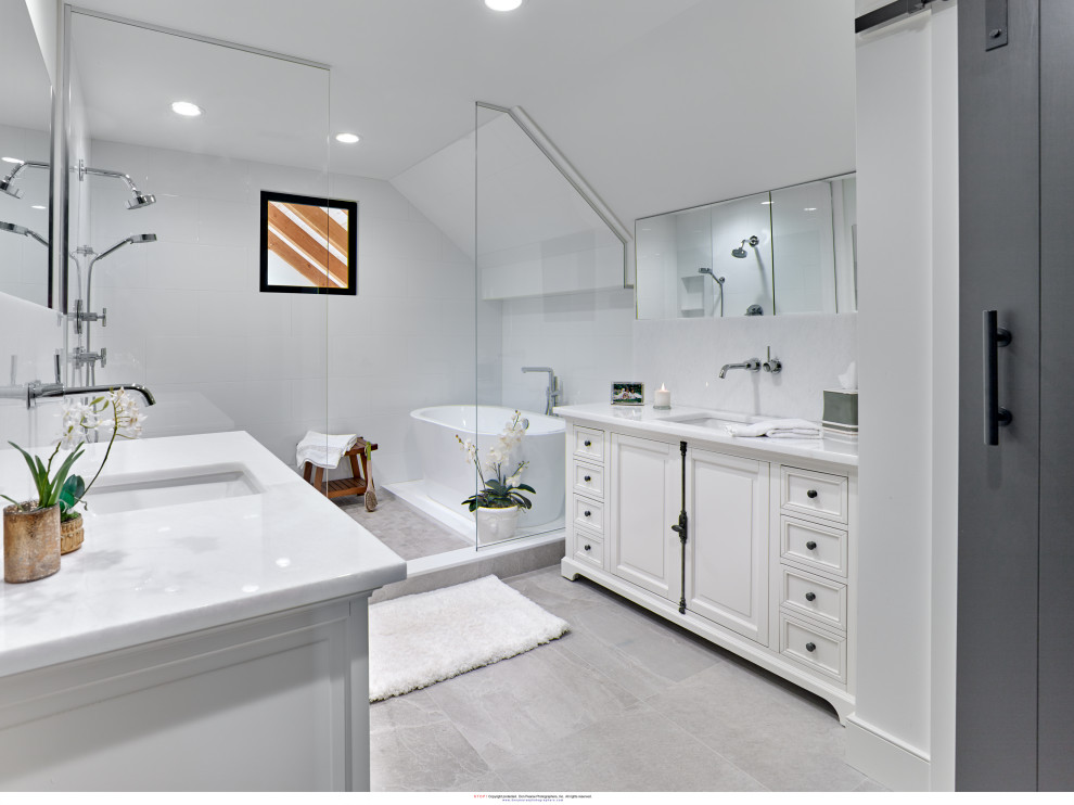 This is an example of a medium sized rural ensuite bathroom in Philadelphia with raised-panel cabinets, white cabinets, a freestanding bath, a walk-in shower, a two-piece toilet, white tiles, porcelain tiles, white walls, marble flooring, a submerged sink, quartz worktops, grey floors, an open shower, white worktops, double sinks and a built in vanity unit.