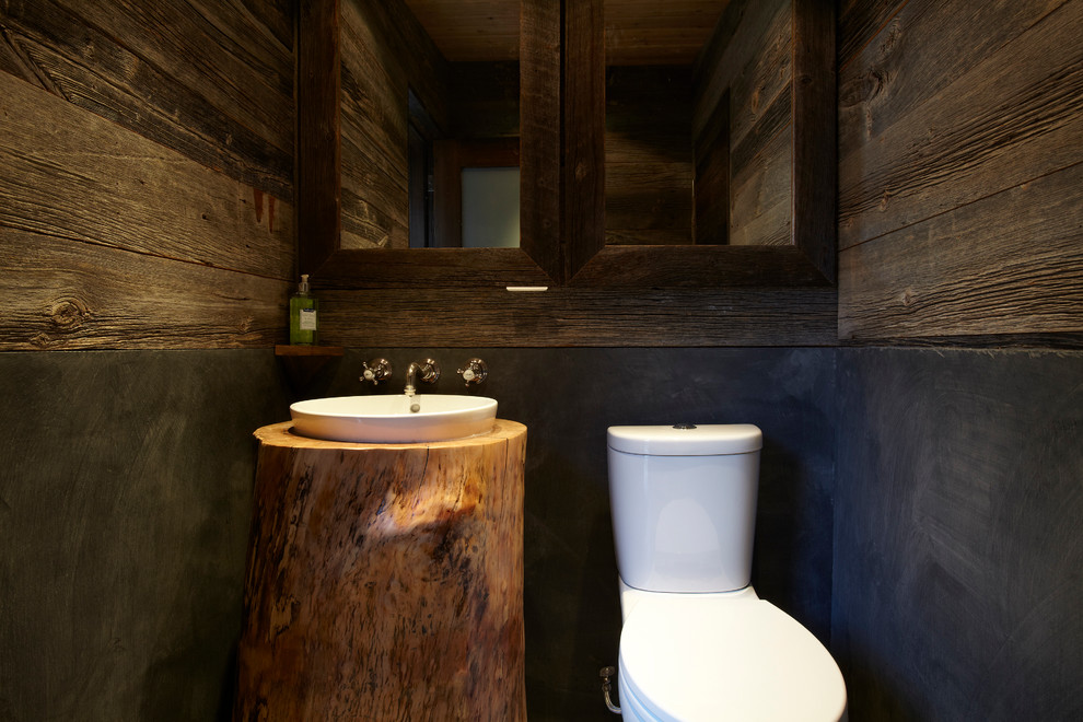 This is an example of a mid-sized scandinavian bathroom in Toronto with flat-panel cabinets, brown cabinets, an open shower, black tile, brown walls, concrete floors, with a sauna and wood benchtops.