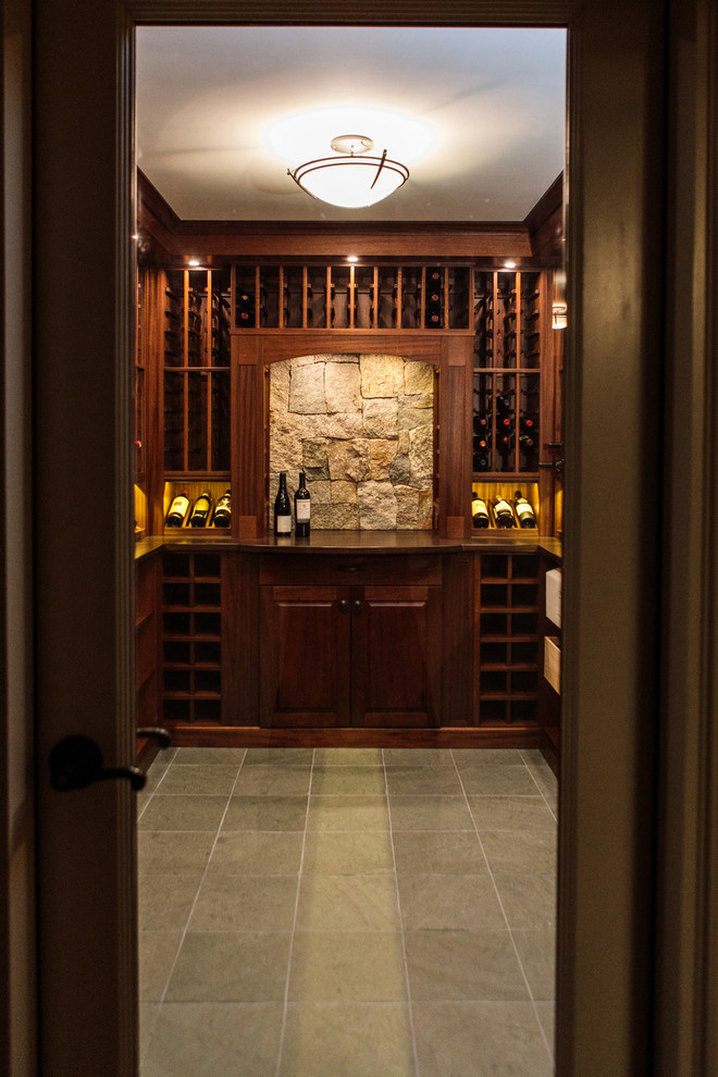 Inspiration for a mid-sized traditional wine cellar in Boston with storage racks and grey floor.