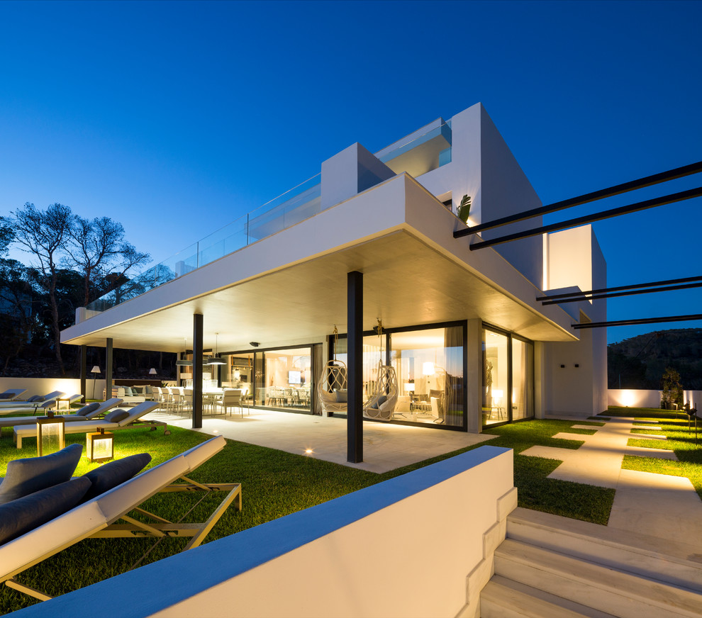 Large contemporary three-storey stucco white exterior in Bilbao with a flat roof.
