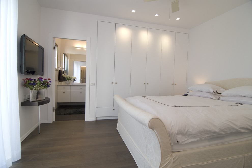 Inspiration for a modern bedroom in Other with white walls and dark hardwood floors.