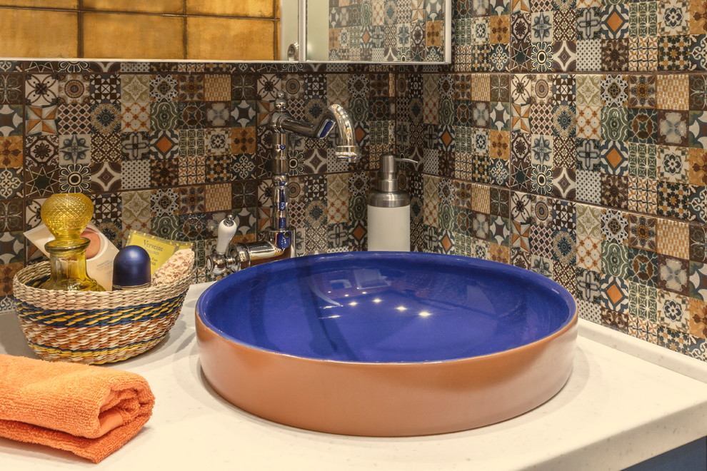 Design ideas for a mid-sized eclectic 3/4 bathroom in Moscow with flat-panel cabinets, blue cabinets, an alcove shower, multi-coloured tile, ceramic tile, orange walls, porcelain floors, a vessel sink and solid surface benchtops.