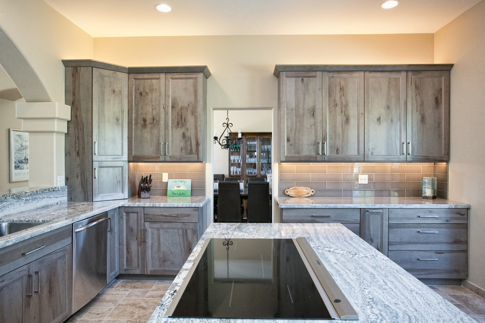 Small mountain style l-shaped ceramic tile eat-in kitchen photo in Phoenix with an undermount sink, flat-panel cabinets, gray cabinets, granite countertops, gray backsplash, ceramic backsplash, stainless steel appliances and an island