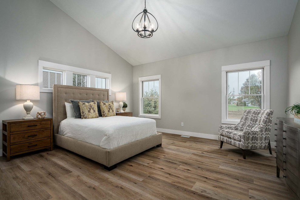 This is an example of a large traditional master bedroom in Other with beige walls, vinyl flooring, no fireplace and brown floors.