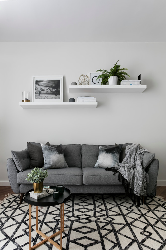 Design ideas for a scandinavian living room in London with white walls.