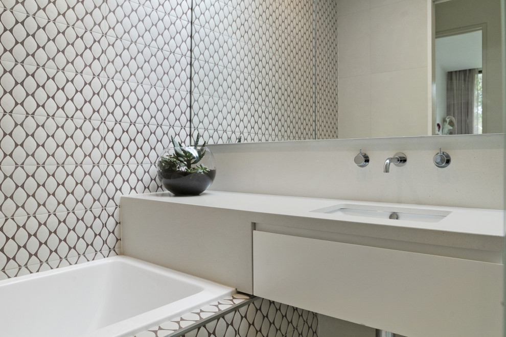Inspiration for a mid-sized contemporary kids bathroom in Melbourne with flat-panel cabinets, white cabinets, a drop-in tub, an open shower, beige tile, cement tile, beige walls, concrete floors, an undermount sink, engineered quartz benchtops, beige floor, beige benchtops, a single vanity and a floating vanity.
