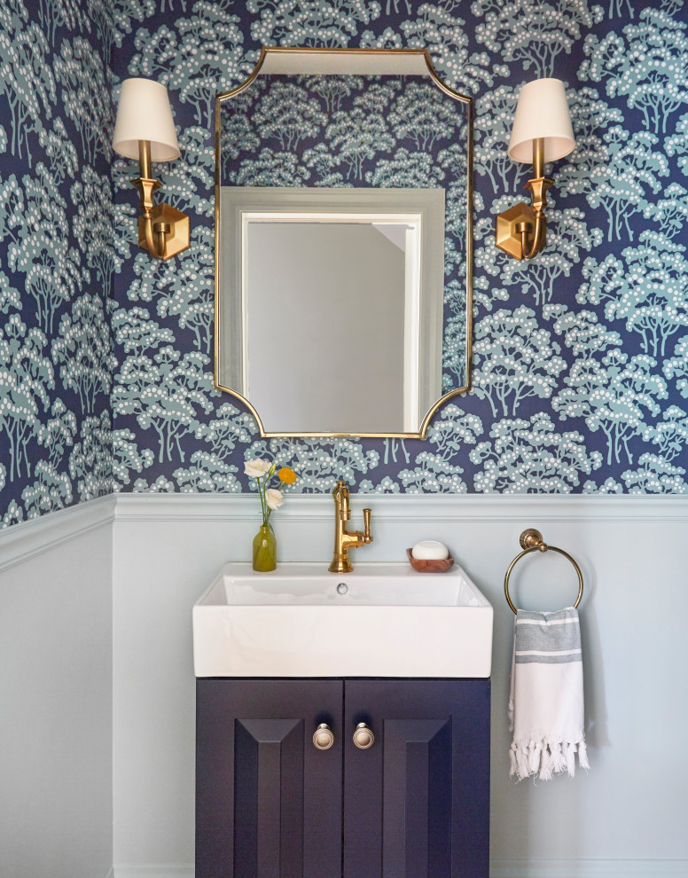 Inspiration for a small timeless medium tone wood floor and brown floor powder room remodel in Chicago with raised-panel cabinets, blue cabinets, a one-piece toilet, blue walls, a vessel sink and a freestanding vanity