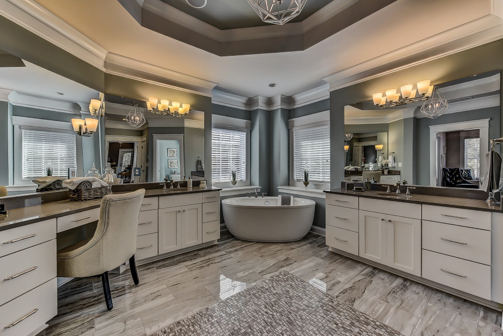 Design ideas for an expansive master bathroom in Charlotte with flat-panel cabinets, white cabinets, a freestanding tub, blue walls, ceramic floors, an undermount sink, grey floor, a double vanity, a built-in vanity and recessed.