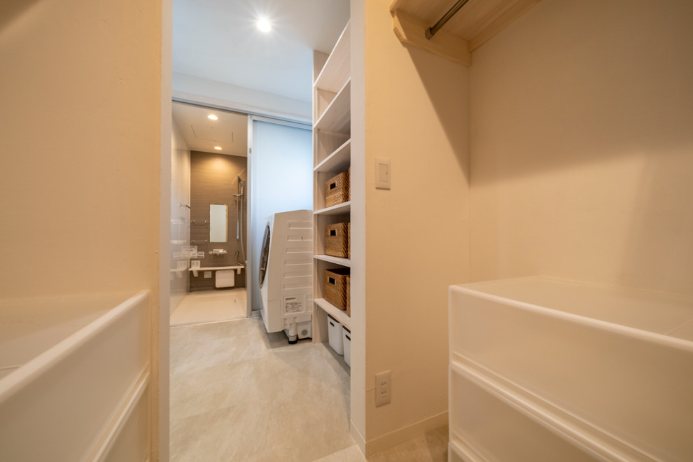 This is an example of a mid-sized contemporary gender-neutral walk-in wardrobe in Other with open cabinets, white cabinets, vinyl floors and white floor.