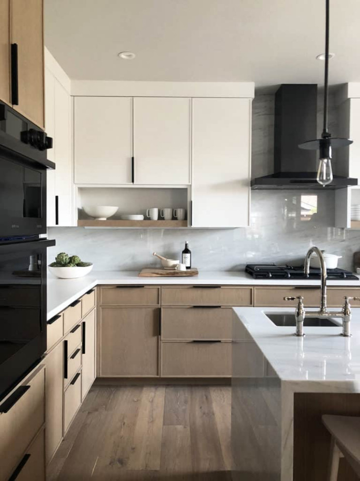 Inspiration for a large contemporary l-shaped open plan kitchen in Columbus with an undermount sink, medium wood cabinets, quartzite benchtops, white splashback, marble splashback, stainless steel appliances, medium hardwood floors, with island, brown floor, white benchtop and flat-panel cabinets.