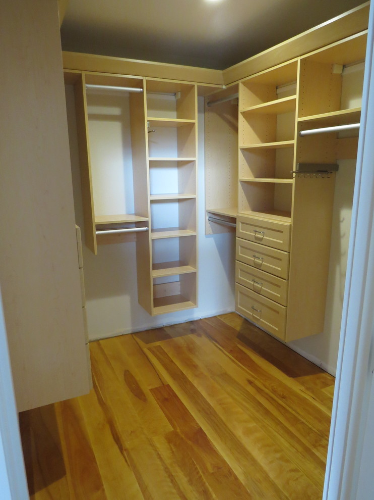 Photo of a mid-sized traditional gender-neutral walk-in wardrobe in Boston with shaker cabinets and medium hardwood floors.