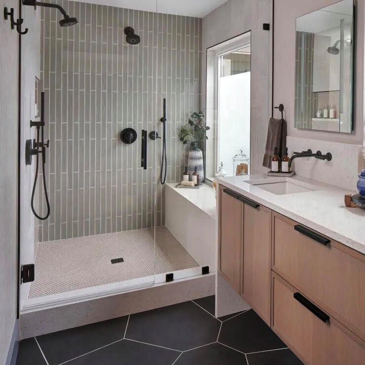 Photo of a mid-sized modern bathroom in Other with a one-piece toilet, multi-coloured tile, ceramic tile, an undermount sink, quartzite benchtops, black floor, a hinged shower door, a shower seat and a single vanity.