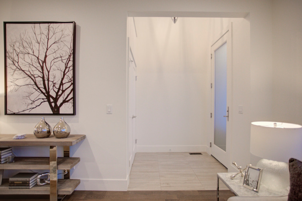 Example of a transitional home design design in Calgary