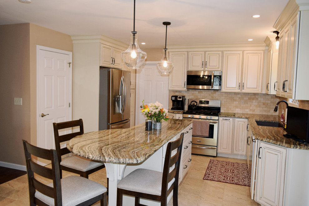 Kitchen - transitional porcelain tile kitchen idea with an undermount sink, raised-panel cabinets, white cabinets, quartz countertops, beige backsplash, porcelain backsplash, stainless steel appliances and an island