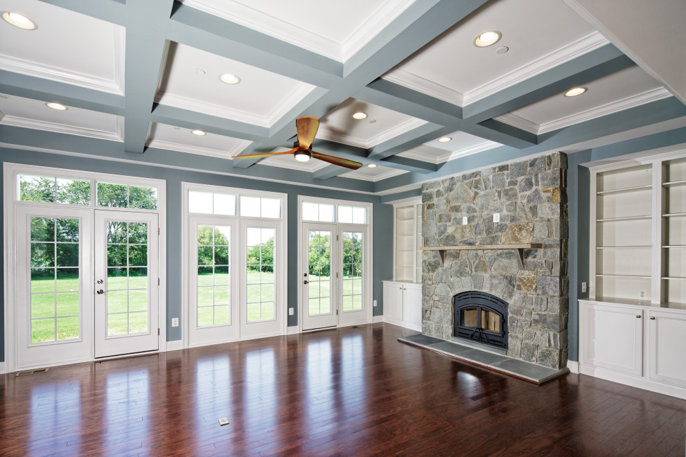 Design ideas for a mid-sized traditional formal open concept living room in DC Metro with a stone fireplace surround, brown floor, coffered, blue walls, dark hardwood floors, no tv and a standard fireplace.