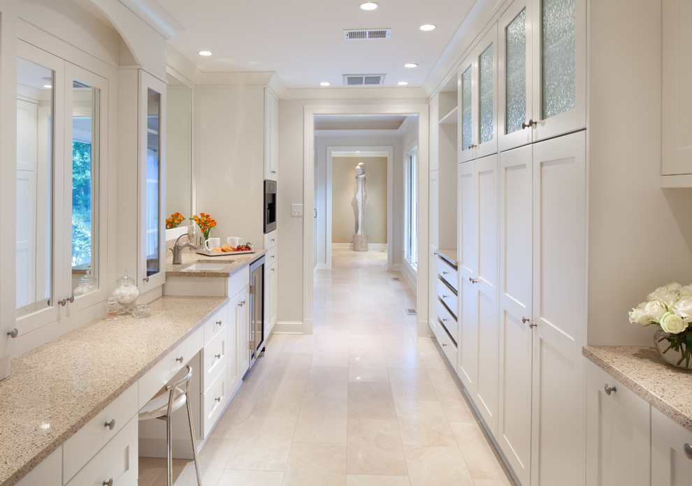 Design ideas for a traditional dressing room in DC Metro with white cabinets and travertine floors.