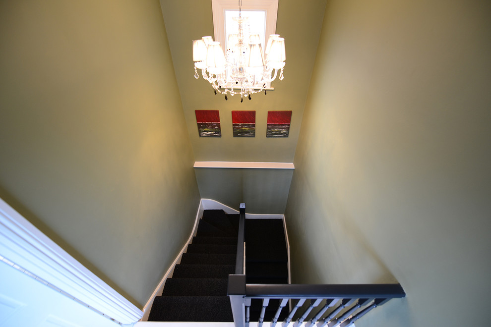 Inspiration for a large transitional carpeted u-shaped staircase in London with carpet risers.