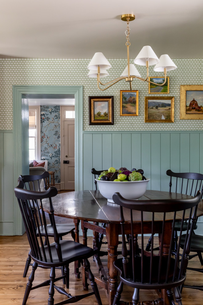 Dining room - country medium tone wood floor, brown floor, wainscoting and wallpaper dining room idea in Salt Lake City with green walls