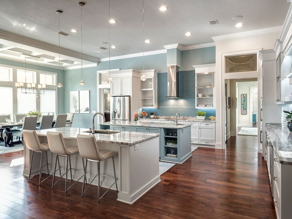 Inspiration for a large transitional l-shaped eat-in kitchen in Miami with an undermount sink, shaker cabinets, white cabinets, marble benchtops, blue splashback, subway tile splashback, stainless steel appliances, medium hardwood floors and multiple islands.
