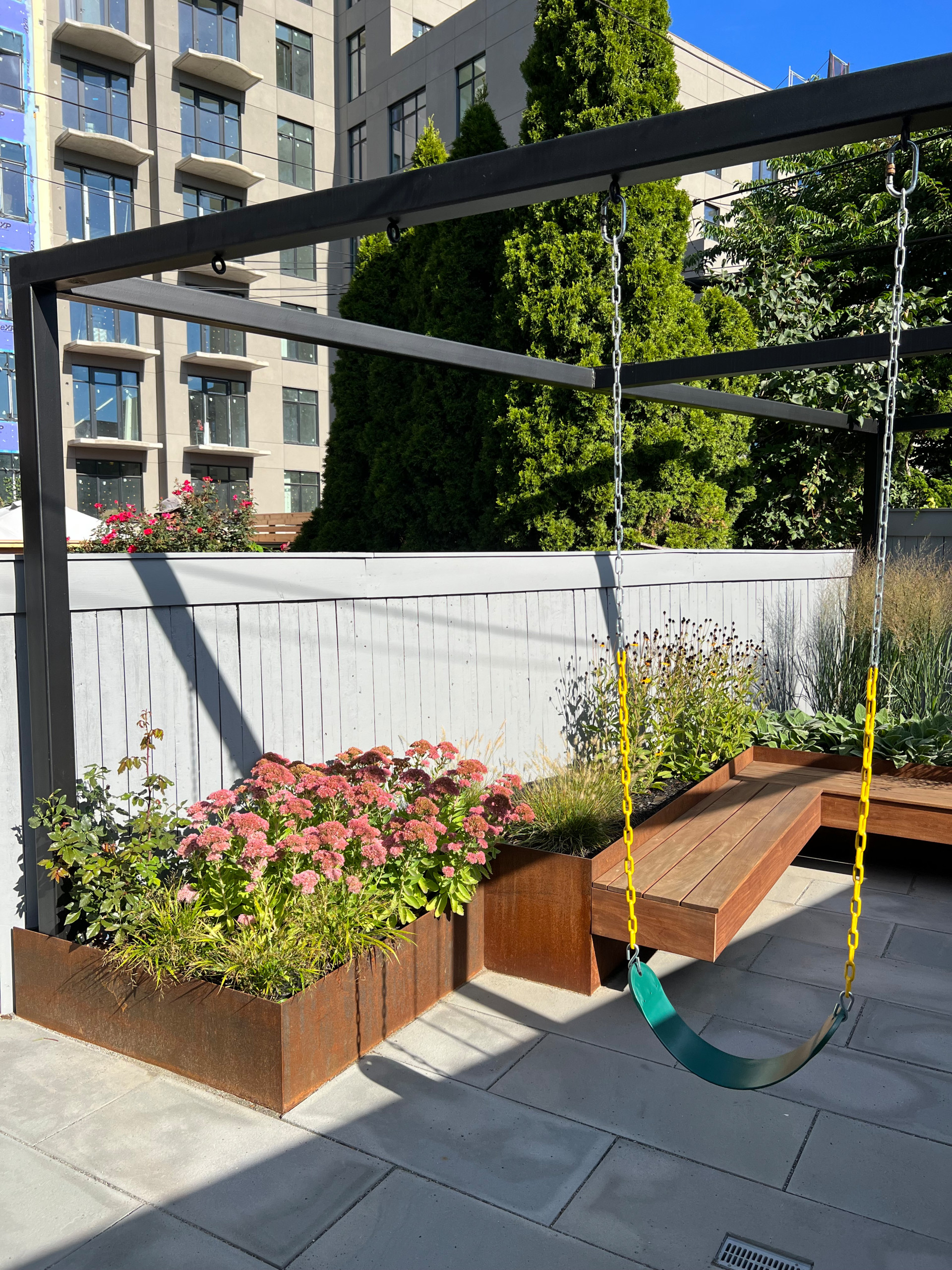 Paved patio with metal grating garden