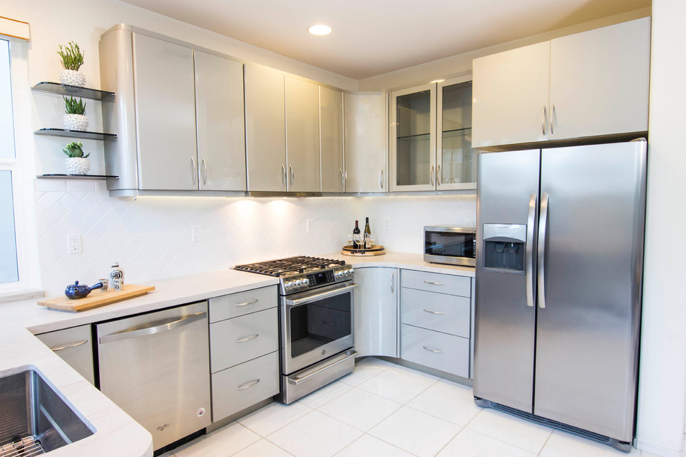 Mid-sized contemporary u-shaped eat-in kitchen in San Diego with an undermount sink, flat-panel cabinets, grey cabinets, quartzite benchtops, white splashback, subway tile splashback, stainless steel appliances, ceramic floors, no island, white floor and white benchtop.