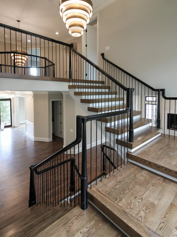Expansive bohemian wood u-shaped mixed railing staircase in DC Metro with wood risers.
