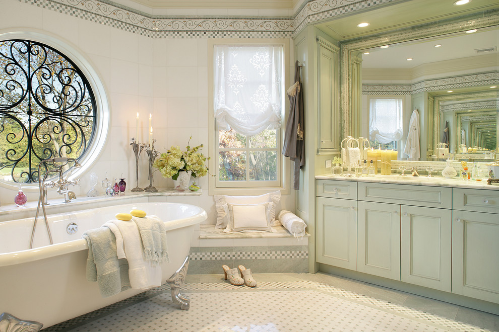 Inspiration for a traditional bathroom in New York with green cabinets, a claw-foot tub, mosaic tile and mosaic tile floors.