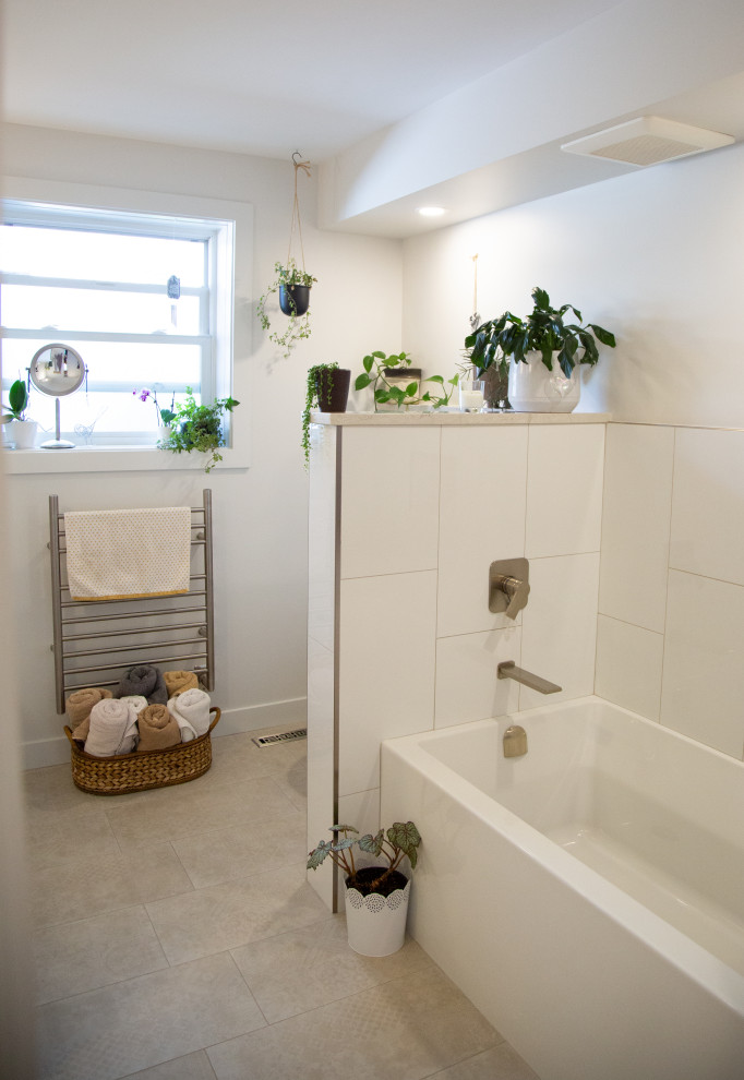 This is an example of a medium sized contemporary ensuite bathroom in Edmonton with a built in vanity unit, flat-panel cabinets, white cabinets, quartz worktops, a single sink, an alcove bath, a built-in shower, multi-coloured tiles, porcelain tiles, an open shower, white worktops, a wall mounted toilet, white walls, porcelain flooring, a vessel sink, beige floors and a wall niche.