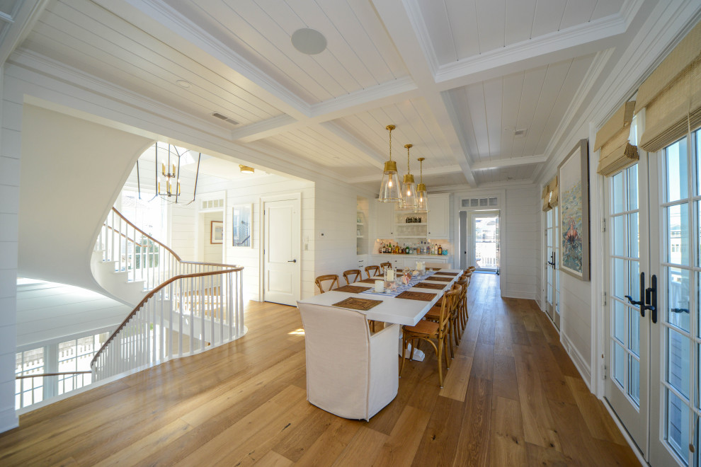 Photo of a large traditional kitchen/dining combo in Philadelphia with white walls, light hardwood floors, no fireplace, multi-coloured floor, coffered and wood walls.