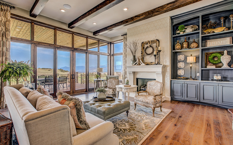 Design ideas for a large traditional open concept family room in Denver with beige walls, medium hardwood floors, a standard fireplace and a tile fireplace surround.