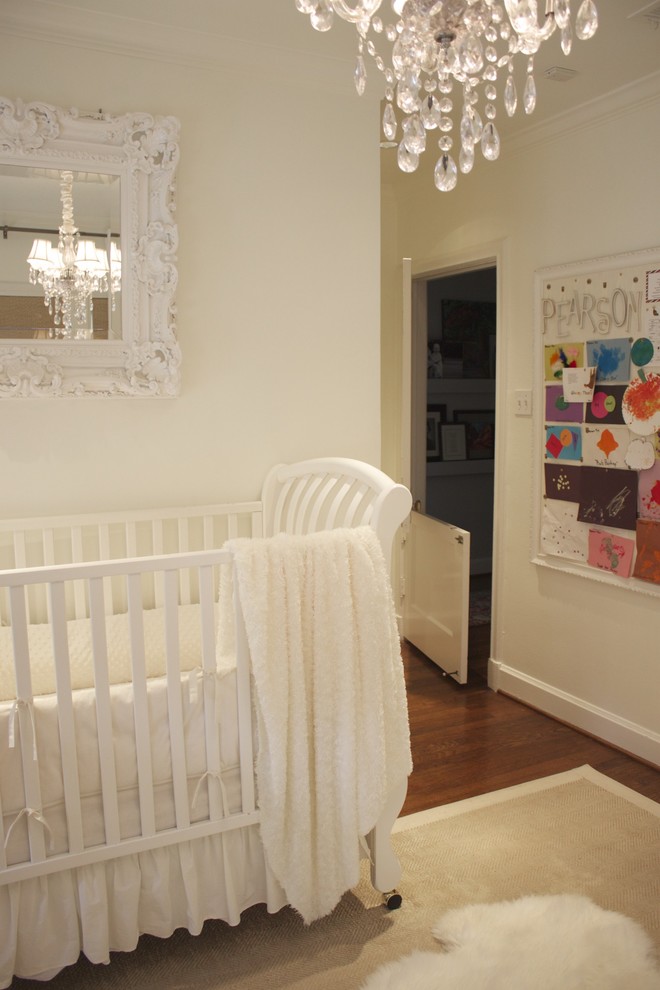 Example of a classic girl nursery design in Dallas with white walls