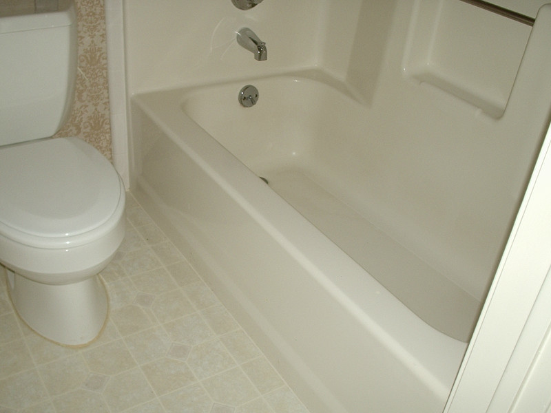 Ceramic tile bathroom photo in Houston with dark wood cabinets