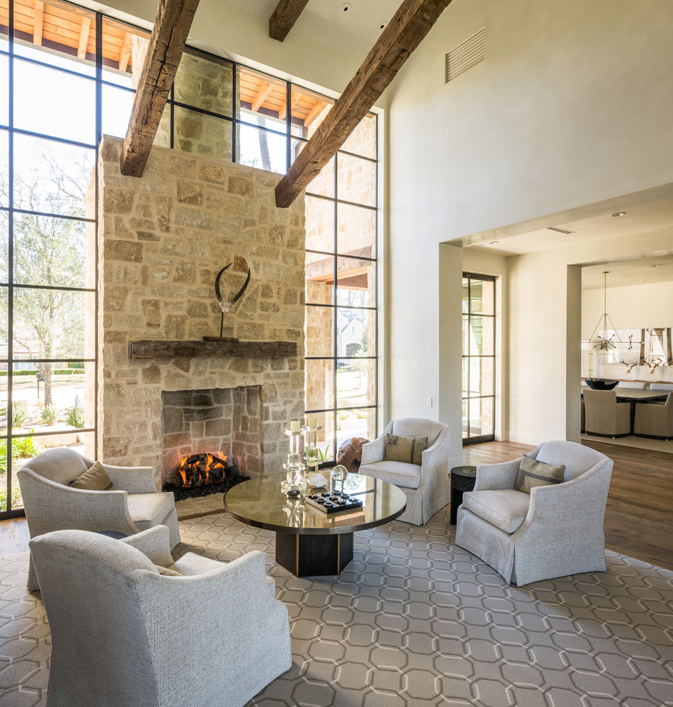 Contemporary open concept living room in Houston with beige walls, medium hardwood floors, a standard fireplace and a stone fireplace surround.