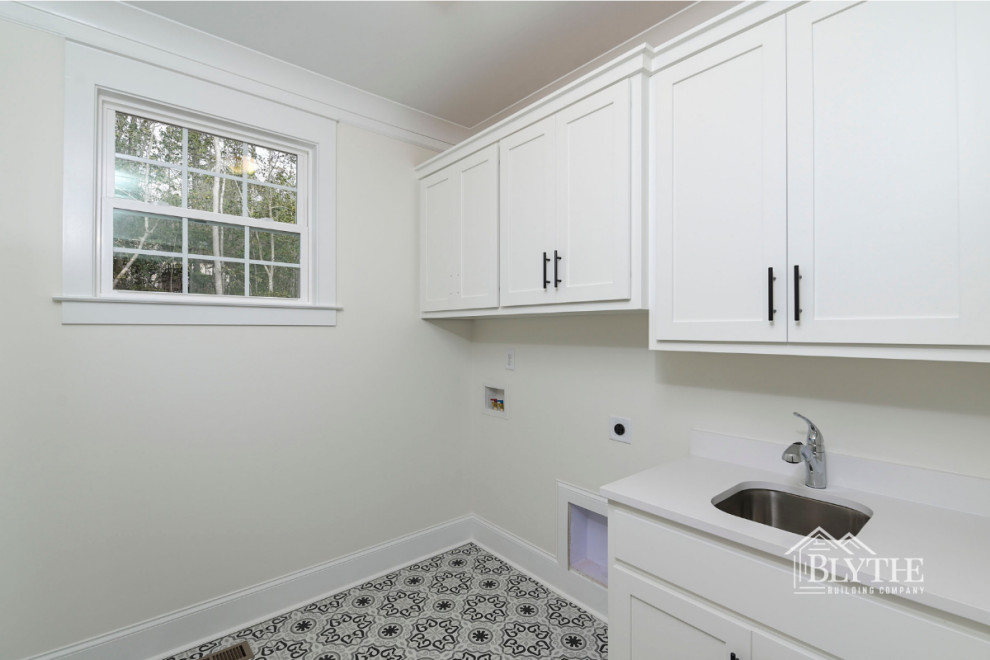 Mid-sized arts and crafts single-wall porcelain tile and multicolored floor dedicated laundry room photo in Other with an undermount sink, shaker cabinets, white cabinets, white walls, a side-by-side washer/dryer and white countertops