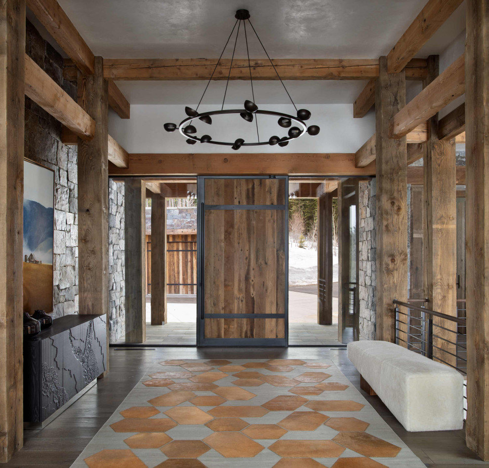 Pivot front door - rustic dark wood floor pivot front door idea with a medium wood front door