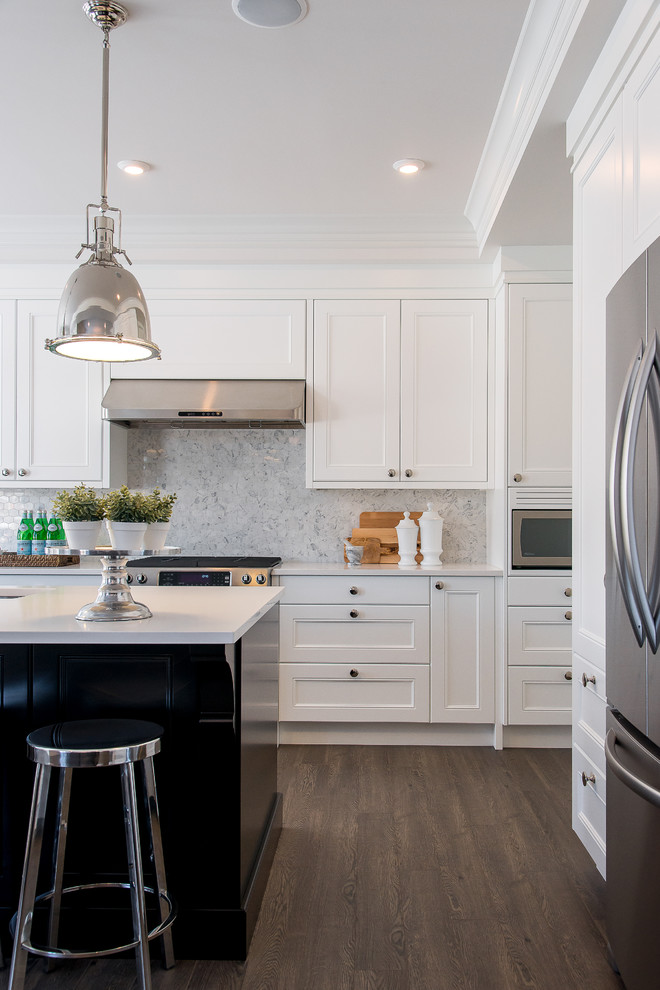 Example of a large transitional l-shaped dark wood floor eat-in kitchen design in Calgary with an undermount sink, recessed-panel cabinets, white cabinets, quartz countertops, multicolored backsplash, mosaic tile backsplash, stainless steel appliances and an island