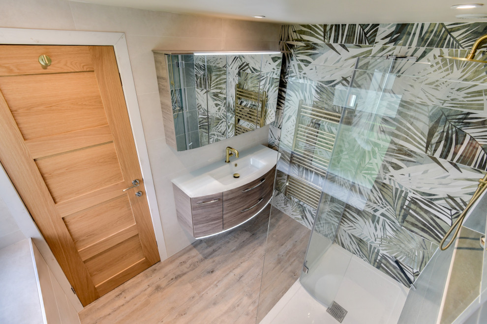 Foto på ett mellanstort tropiskt vit toalett, med släta luckor, skåp i mellenmörkt trä, en toalettstol med hel cisternkåpa, grön kakel, keramikplattor, flerfärgade väggar, mellanmörkt trägolv, ett nedsänkt handfat och brunt golv