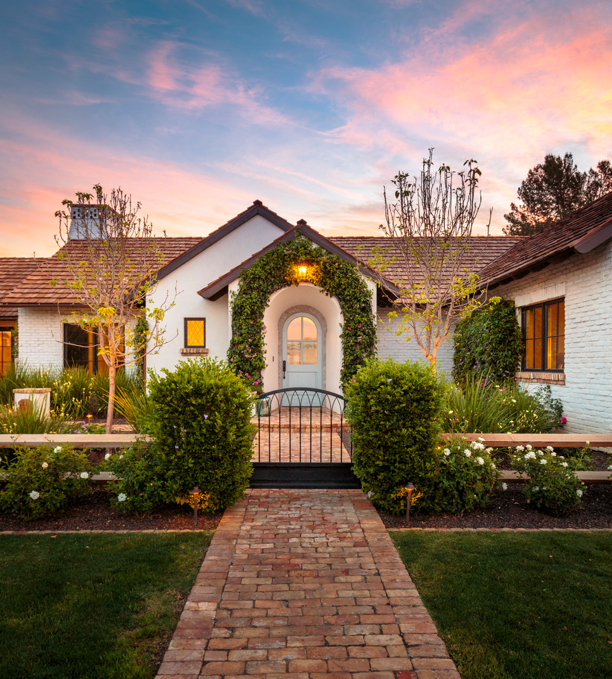 Example of a classic entryway design in Phoenix with a glass front door