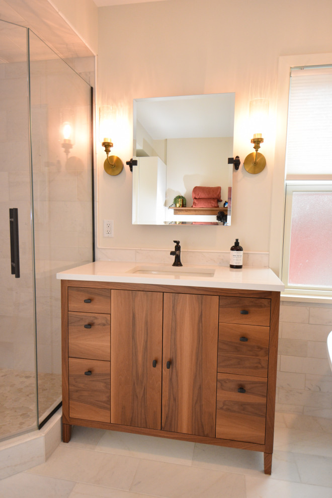 Photo of a mid-sized contemporary master bathroom in Minneapolis with flat-panel cabinets, medium wood cabinets, a freestanding tub, a corner shower, a one-piece toilet, beige tile, beige walls, porcelain floors, an undermount sink, granite benchtops, beige floor, a hinged shower door, white benchtops, a niche, a single vanity, a freestanding vanity and coffered.