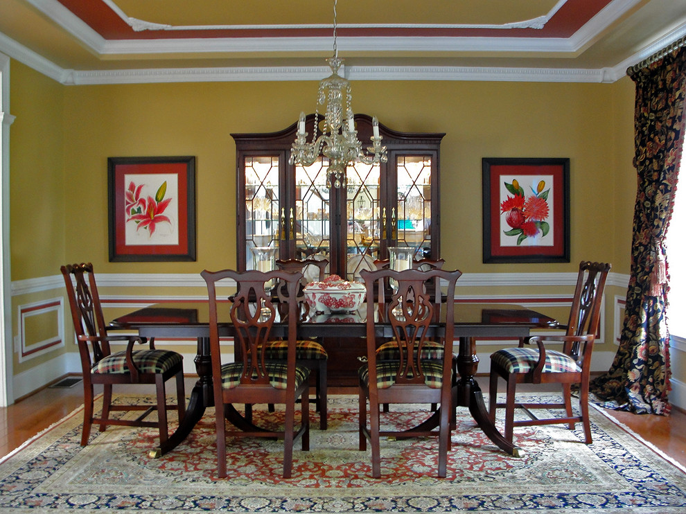 Mid-sized traditional separate dining room in DC Metro with medium hardwood floors, yellow walls and no fireplace.