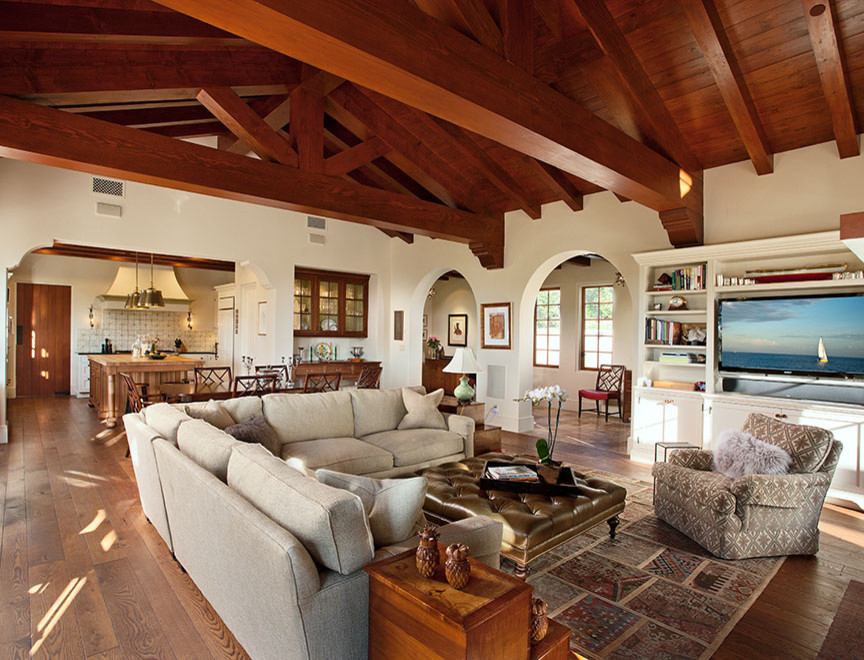 Photo of a large mediterranean open concept family room in Santa Barbara with white walls, dark hardwood floors and a built-in media wall.