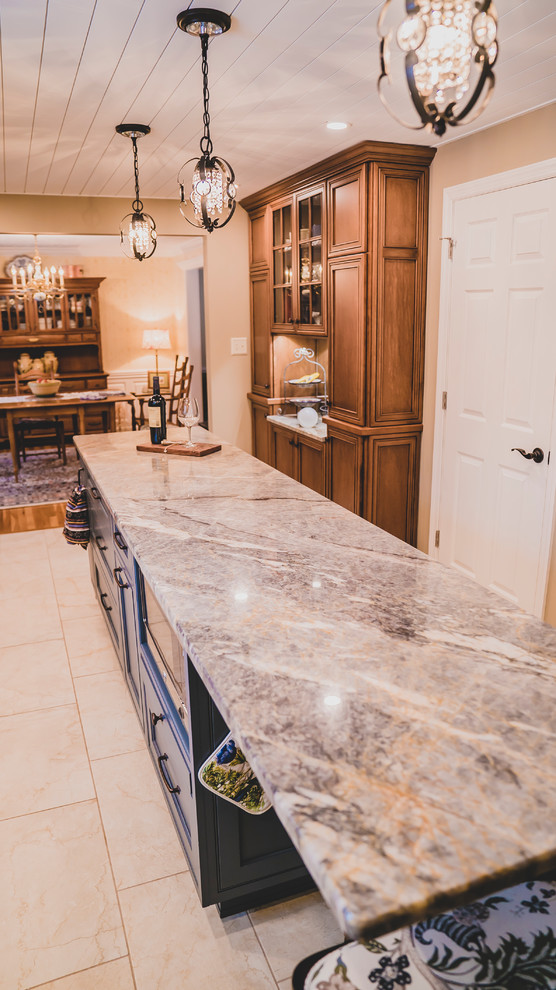 Mid-sized transitional porcelain tile and beige floor eat-in kitchen photo with an undermount sink, shaker cabinets, medium tone wood cabinets, quartzite countertops, ceramic backsplash, stainless steel appliances, an island, multicolored countertops and white backsplash